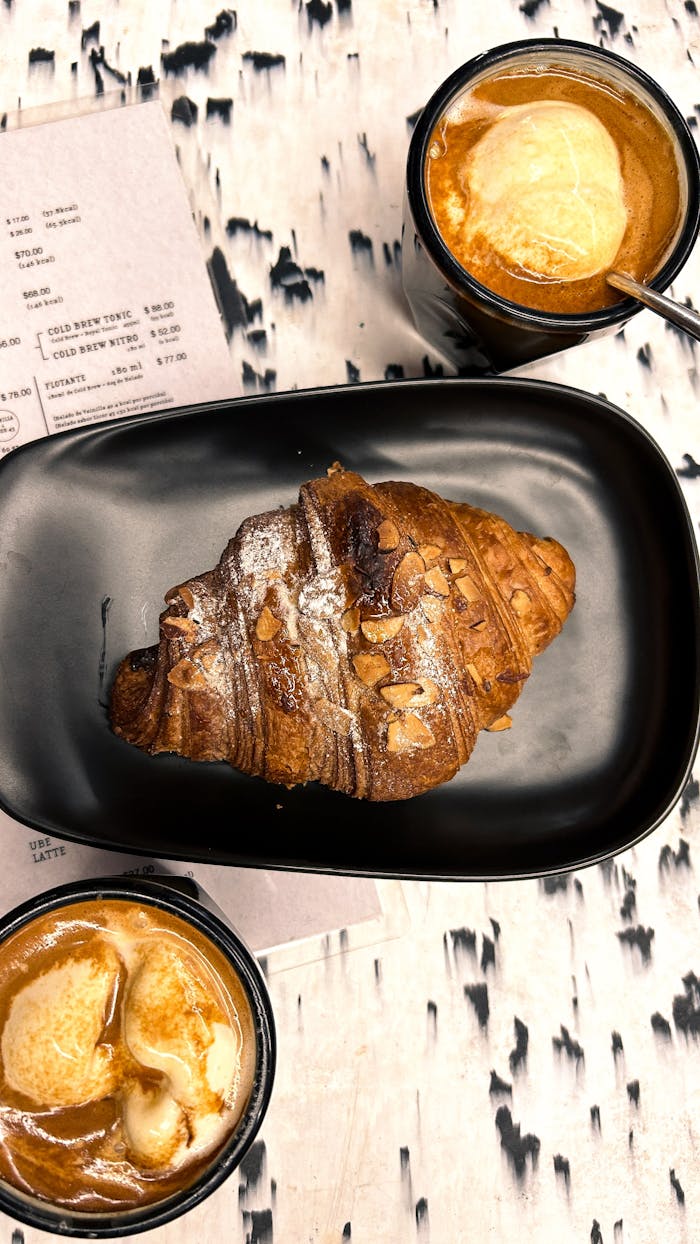 A delectable croissant with affogato coffee on a stylish table for a cozy cafe vibe.