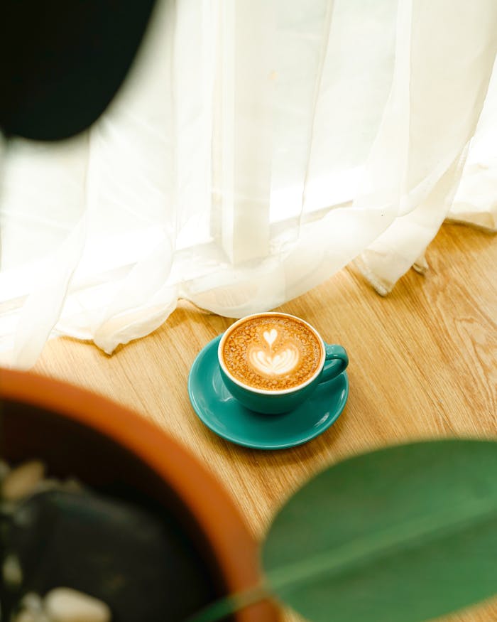 A warm cup of cafe latte with heart-shaped art in a serene setting, perfect for cozy mornings.